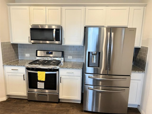 201 Abby Rd, Georgetown, TX 78626 - kitchen with appliances with stainless steel finishes, stone counters, dark wood-style floors, and white cabinetry