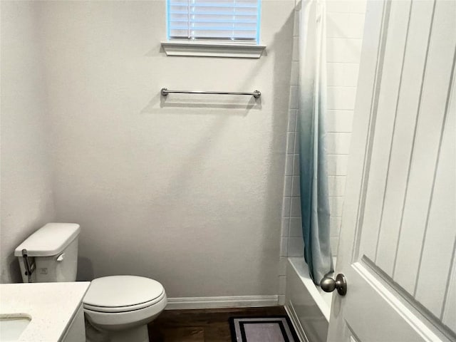 201 Abby Rd, Georgetown, TX 78626 - bathroom with baseboards, vanity, toilet, shower / tub combo, and wood finished floors