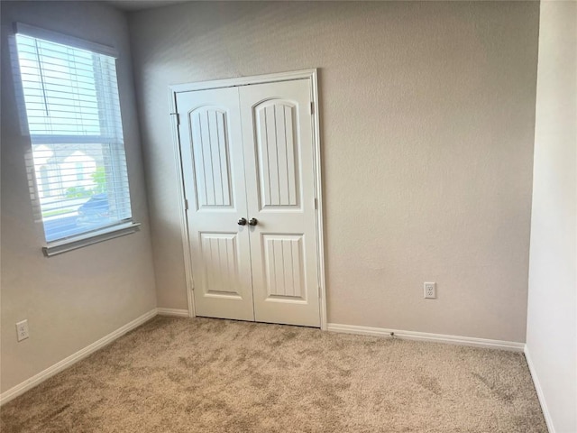 201 Abby Rd, Georgetown, TX 78626 - unfurnished bedroom with carpet floors, multiple windows, and a closet