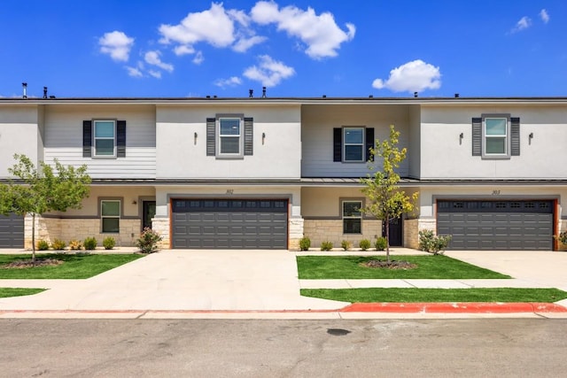 2105 Tiger Trl Unit 302, Round Rock, TX 78665 - multi unit property with a garage, concrete driveway, stucco siding, and stone siding