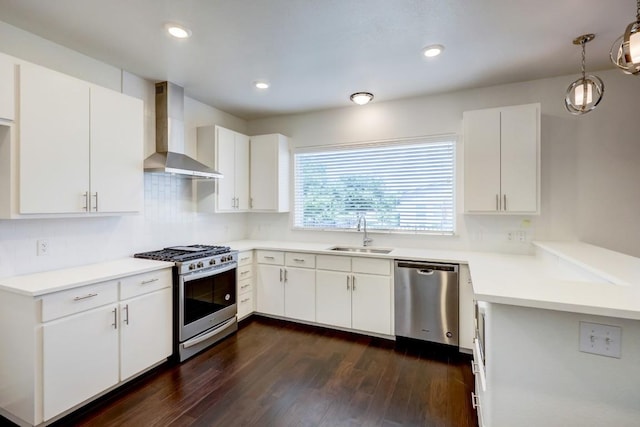 2105 Tiger Trl Unit 302, Round Rock, TX 78665 - kitchen with stainless steel appliances, wall chimney range hood, a sink, dark wood-style flooring, and recessed lighting