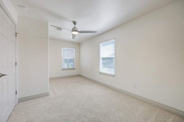 2105 Tiger Trl Unit 302, Round Rock, TX 78665 - unfurnished bedroom featuring light carpet, baseboards, and ceiling fan