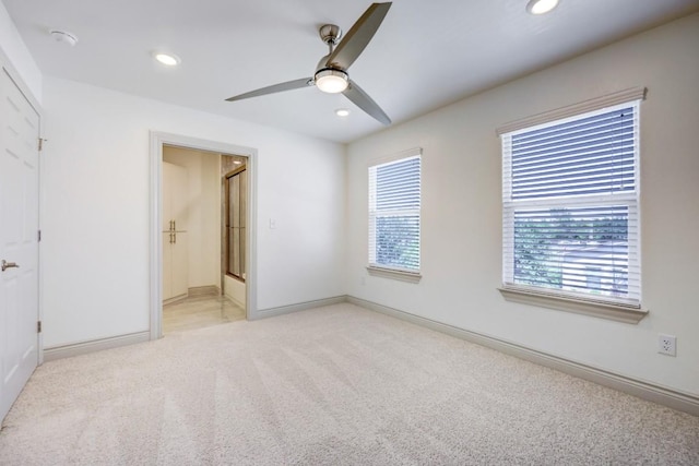 2105 Tiger Trl Unit 302, Round Rock, TX 78665 - unfurnished bedroom with light colored carpet, recessed lighting, baseboards, ceiling fan, and ensuite bathroom