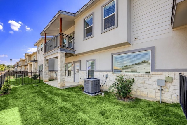 2105 Tiger Trl Unit 302, Round Rock, TX 78665 - back of property featuring a balcony, cooling unit, stucco siding, a patio area, and stone siding
