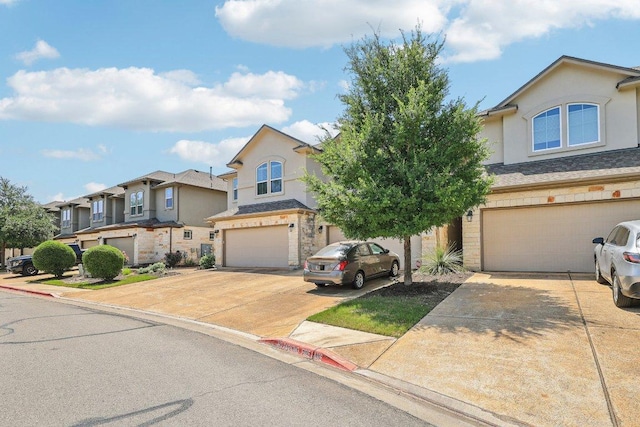 13400 Briarwick Dr Unit 1202, Austin, TX 78729 - traditional home with an attached garage, driveway, stucco siding, stone siding, and a residential view