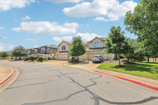 13400 Briarwick Dr Unit 1202, Austin, TX 78729 - view of front facade with stucco siding, an attached garage, driveway, a residential view, and a front lawn