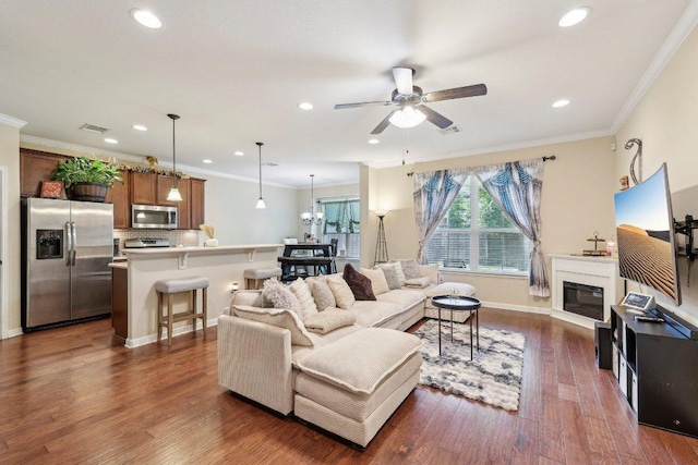 13400 Briarwick Dr Unit 1202, Austin, TX 78729 - living area featuring a ceiling fan, recessed lighting, dark wood finished floors, crown molding, and a glass covered fireplace