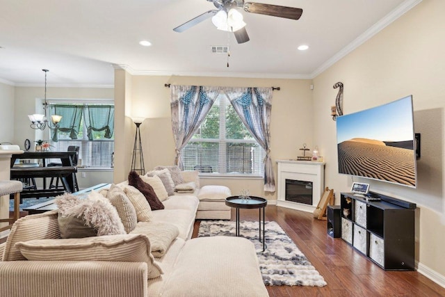 13400 Briarwick Dr Unit 1202, Austin, TX 78729 - living area featuring wood finished floors, ceiling fan, ornamental molding, a glass covered fireplace, and a chandelier