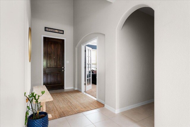 211 Joseph Dr, Buda, TX 78610 - foyer with light tile patterned flooring, arched walkways, and baseboards