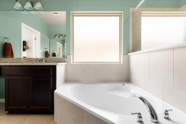 211 Joseph Dr, Buda, TX 78610 - bathroom with a garden tub, vanity, and tile patterned flooring