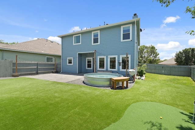 1121 Boxwood Loop, Georgetown, TX 78628 - back of house featuring a hot tub, a patio area, and a chimney