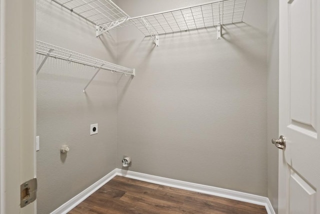 1121 Boxwood Loop, Georgetown, TX 78628 - laundry area with hookup for an electric dryer, baseboards, and dark wood finished floors