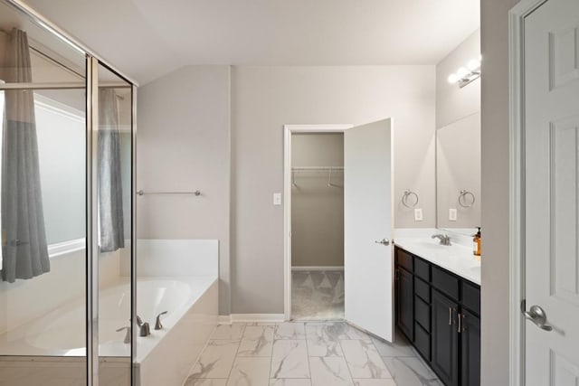 1121 Boxwood Loop, Georgetown, TX 78628 - bathroom featuring a bath, double vanity, marble look tile flooring, a spacious closet, and a stall shower