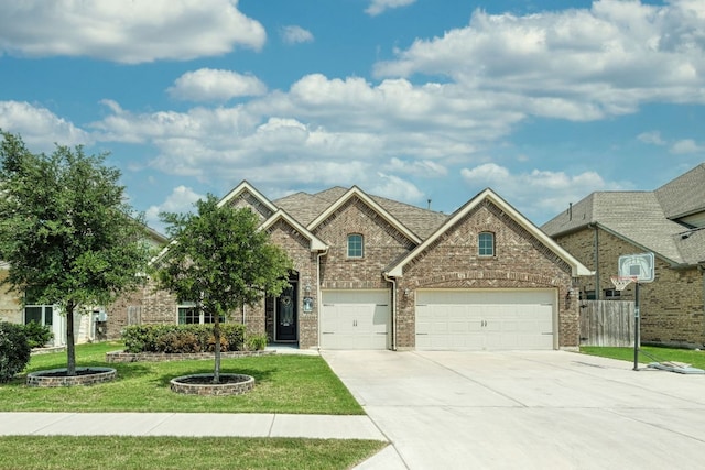 19500 Chayton Cir, Pflugerville, TX 78660 - view of front of home with driveway, a front lawn, and brick siding