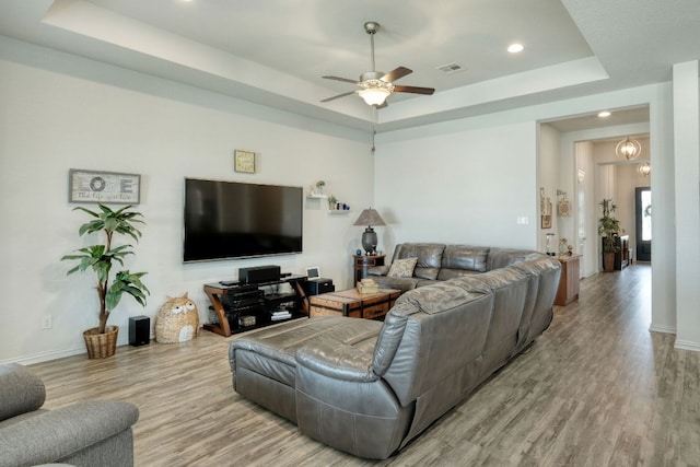 19500 Chayton Cir, Pflugerville, TX 78660 - living room with a tray ceiling, wood finished floors, a ceiling fan, and recessed lighting