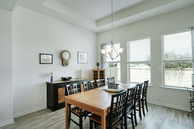 19500 Chayton Cir, Pflugerville, TX 78660 - dining room with light wood-type flooring, a chandelier, baseboards, and a raised ceiling