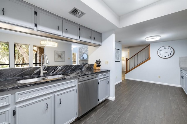 8115 Raintree Pl, Austin, TX 78759 - kitchen featuring stainless steel dishwasher, a sink, baseboards, dark wood-style flooring, and dark stone countertops