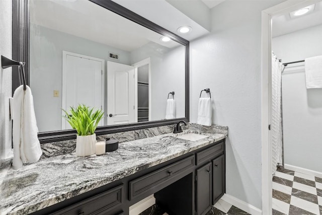8115 Raintree Pl, Austin, TX 78759 - bathroom featuring vanity, baseboards, and recessed lighting