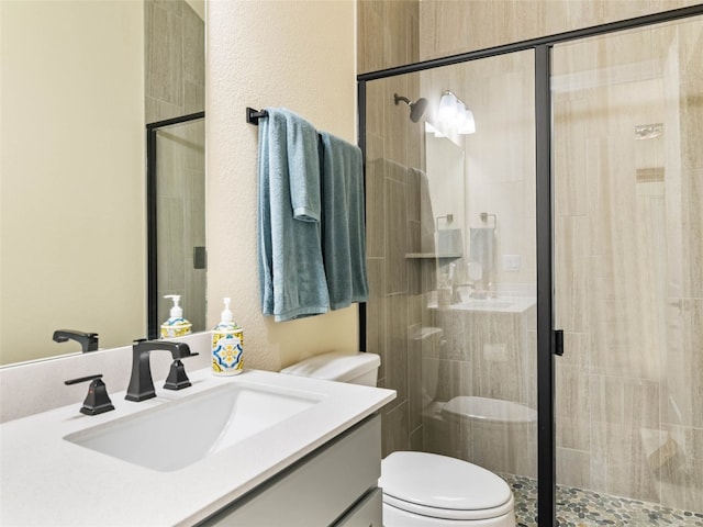 121 Wild Honeysuckle Way, San Marcos, TX 78666 - bathroom with vanity, a shower stall, and a textured wall