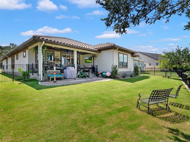 121 Wild Honeysuckle Way, San Marcos, TX 78666 - back of house featuring a fenced backyard, ceiling fan, a tile roof, and stucco siding