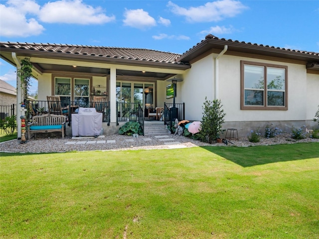 121 Wild Honeysuckle Way, San Marcos, TX 78666 - back of property featuring a lawn, covered porch, and stucco siding