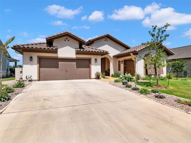 121 Wild Honeysuckle Way, San Marcos, TX 78666 - mediterranean / spanish home featuring a garage, driveway, stucco siding, and a tiled roof