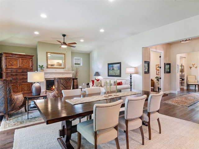 121 Wild Honeysuckle Way, San Marcos, TX 78666 - dining room with wood finished floors, a fireplace, ceiling fan, and recessed lighting