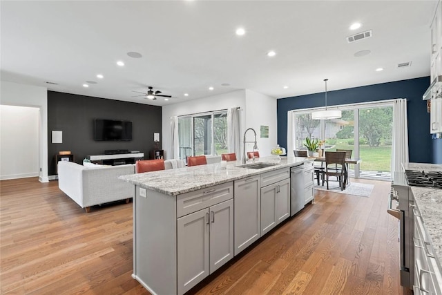 22005 Briarcliff Dr, Spicewood, TX 78669 - kitchen with a sink, appliances with stainless steel finishes, a ceiling fan, recessed lighting, and light wood finished floors