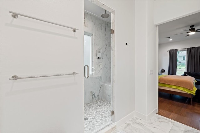 22005 Briarcliff Dr, Spicewood, TX 78669 - ensuite bathroom featuring a marble finish shower, marble finish floors, and a ceiling fan