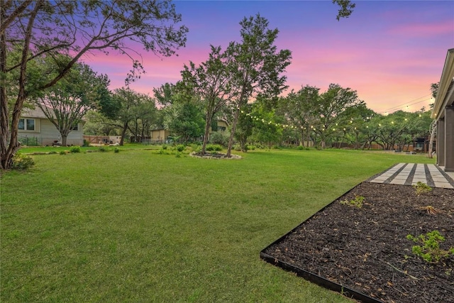 22005 Briarcliff Dr, Spicewood, TX 78669 - yard at dusk with a lawn