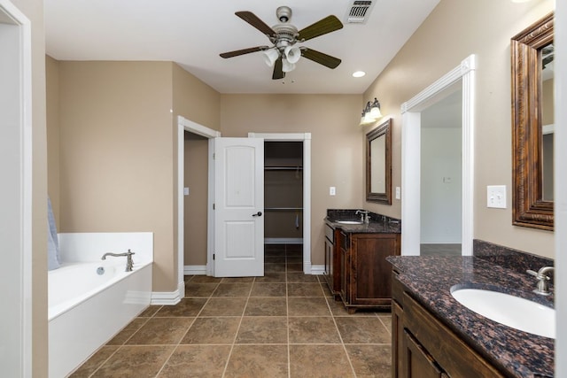 12011 Fm 1150th Rd, Luling, TX 78648 - bathroom featuring two vanities, a ceiling fan, a bath, baseboards, and recessed lighting