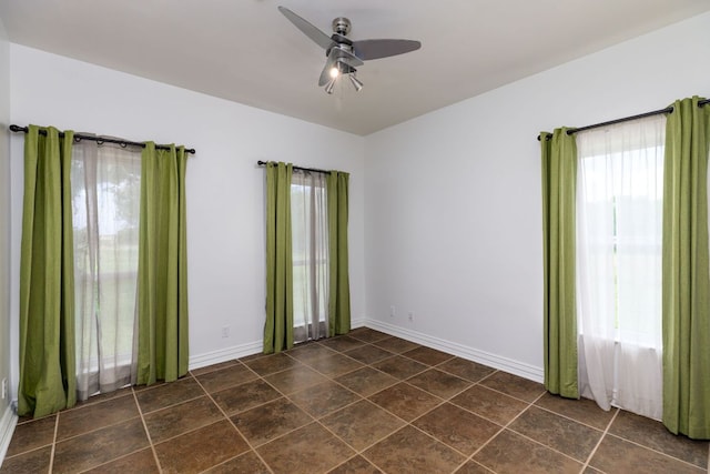 12011 Fm 1150th Rd, Luling, TX 78648 - spare room featuring plenty of natural light, a ceiling fan, and baseboards