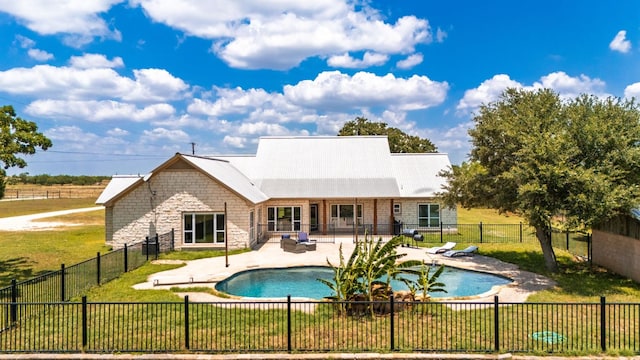 12011 Fm 1150th Rd, Luling, TX 78648 - back of property featuring stone siding, a patio area, and metal roof