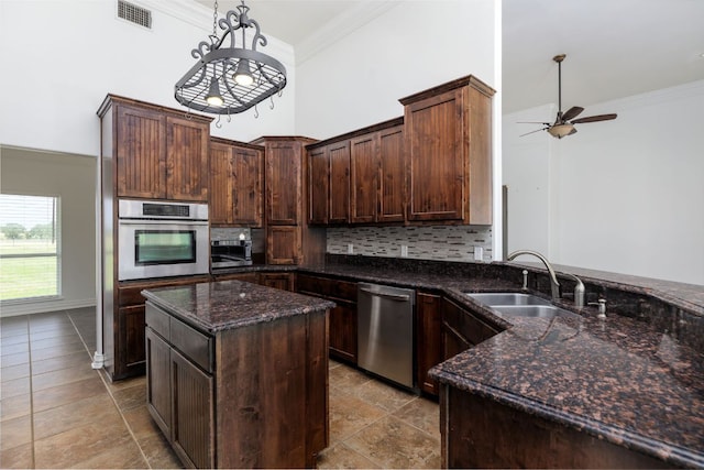 12011 Fm 1150th Rd, Luling, TX 78648 - kitchen with stainless steel appliances, a sink, ornamental molding, tasteful backsplash, and dark stone countertops