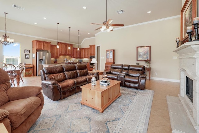 1617 High Lonesome, Leander, TX 78641 - living room featuring light tile patterned floors, ceiling fan, a tiled fireplace, a chandelier, and crown molding