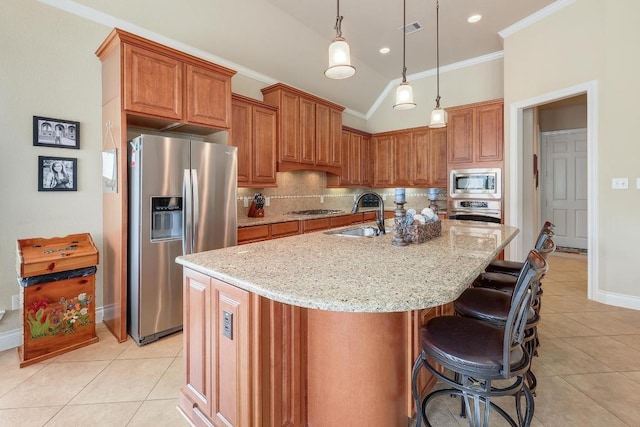 1617 High Lonesome, Leander, TX 78641 - kitchen with stainless steel appliances, a sink, light tile patterned floors, tasteful backsplash, and brown cabinetry