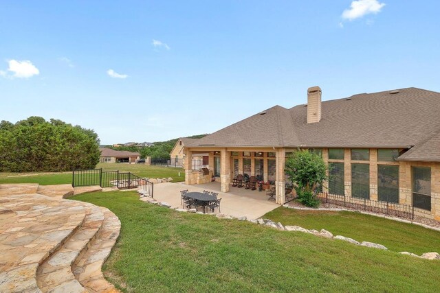 1617 High Lonesome, Leander, TX 78641 - back of house with a patio, a chimney, and roof with shingles