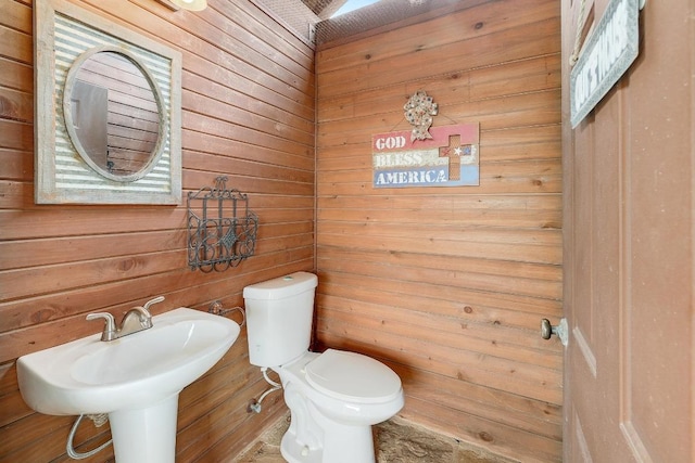 1617 High Lonesome, Leander, TX 78641 - half bathroom with wooden walls, toilet, and a sink