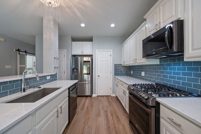 19402 Gale Meadow Dr, Pflugerville, TX 78660 - kitchen with appliances with stainless steel finishes, a sink, white cabinetry, backsplash, and recessed lighting