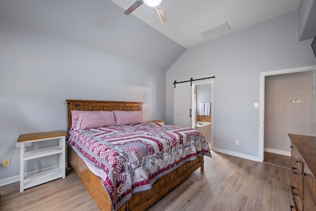 19402 Gale Meadow Dr, Pflugerville, TX 78660 - bedroom featuring vaulted ceiling, wood finished floors, a barn door, baseboards, and ceiling fan