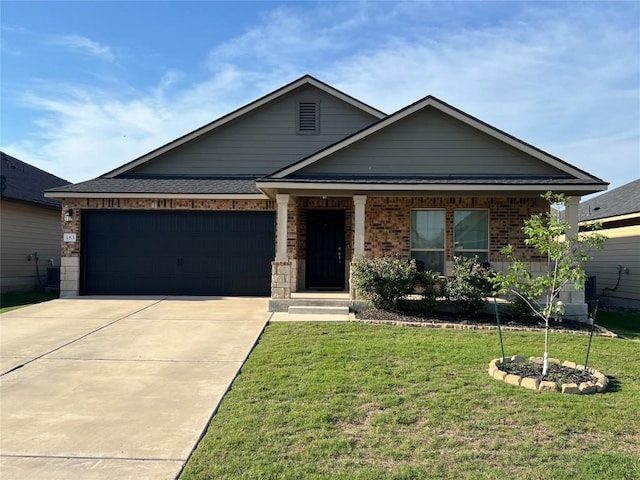 183 Beth Ann Loop, Taylor, TX 76574 - view of front of house featuring concrete driveway, a front yard, an attached garage, and brick siding