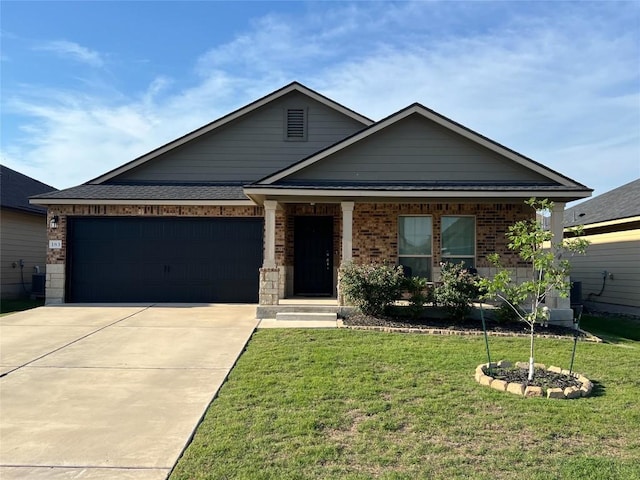 183 Beth Ann Loop, Taylor, TX 76574 - view of front facade with driveway, an attached garage, a front yard, and brick siding
