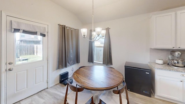 183 Beth Ann Loop, Taylor, TX 76574 - dining area with light wood-style flooring, a chandelier, and vaulted ceiling