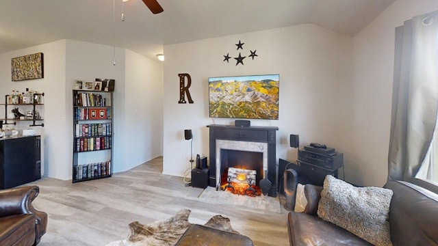 183 Beth Ann Loop, Taylor, TX 76574 - living area with a ceiling fan, a lit fireplace, vaulted ceiling, and light wood finished floors
