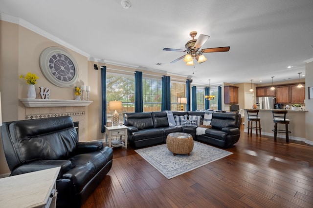 1504 Edelweiss Dr, Cedar Park, TX 78613 - living area featuring ceiling fan, dark wood-style flooring, ornamental molding, a tiled fireplace, and baseboards