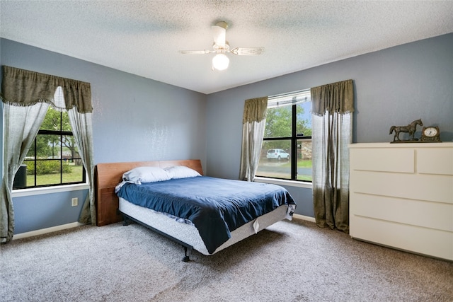838 Pine Ln, Cottonwood Shores, TX 78657 - carpeted bedroom featuring baseboards, a ceiling fan, and a textured ceiling