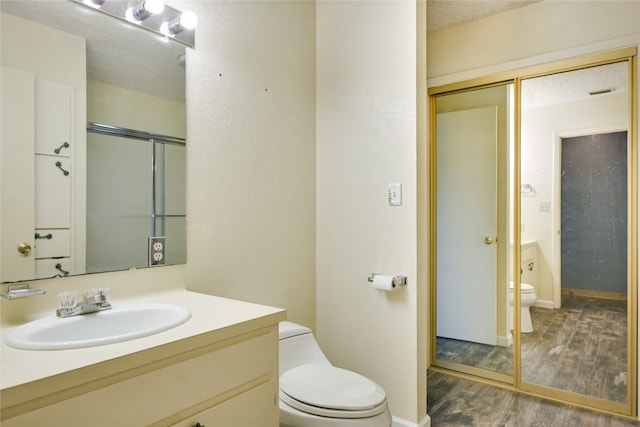 838 Pine Ln, Cottonwood Shores, TX 78657 - bathroom with toilet, wood finished floors, vanity, and a shower