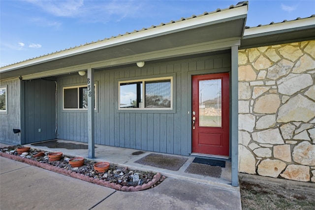 838 Pine Ln, Cottonwood Shores, TX 78657 - entrance to property with stone siding, covered porch, and metal roof