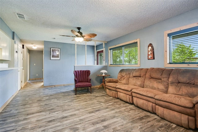 838 Pine Ln, Cottonwood Shores, TX 78657 - living area with healthy amount of natural light, wood finished floors, a textured ceiling, and ceiling fan