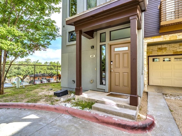 124 Cumberland Rd Unit 401, Austin, TX 78704 - view of exterior entry with stone siding and a garage